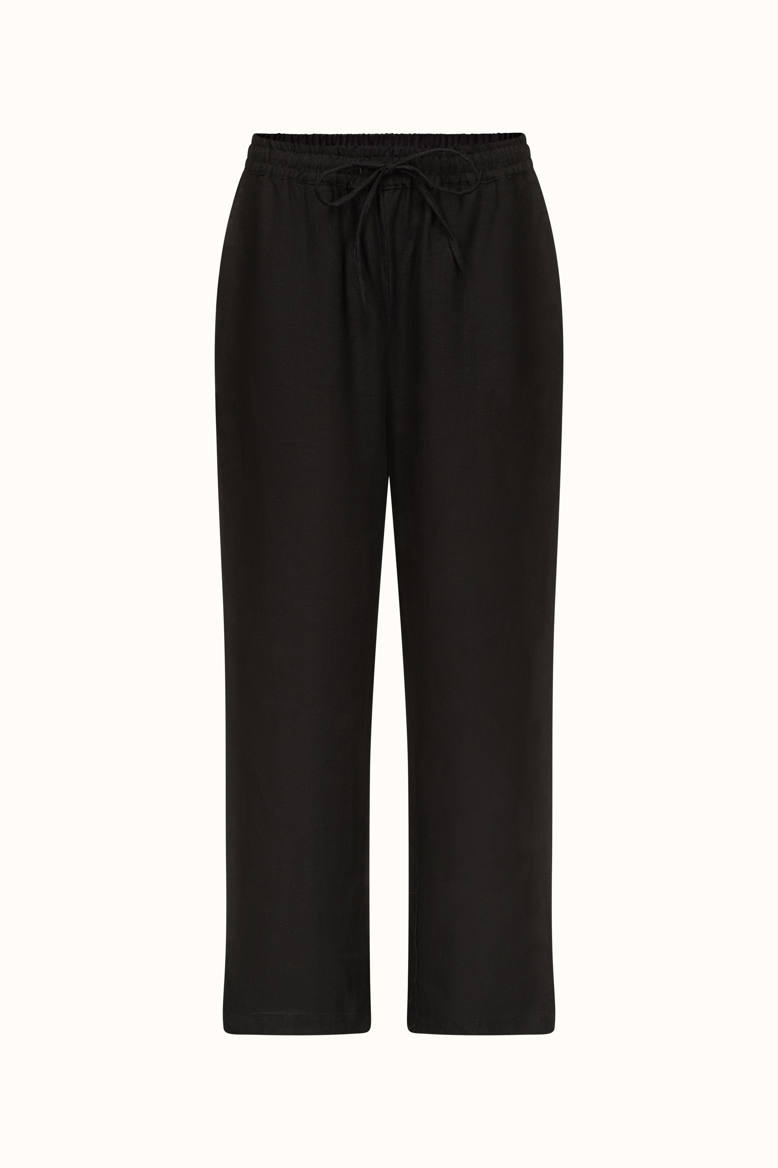 A female model wearing a matching black linen crop top and pyjama trousers set. The outfit includes a square neckline, button-up front on the top, and the trousers have an elasticated waistband.